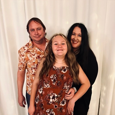 Sam Sveien smiling with her family.